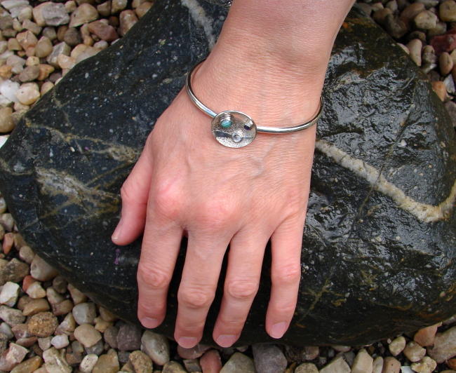'Shifting Tides Sterling Silver Bangle' by artist Marley McKinnie